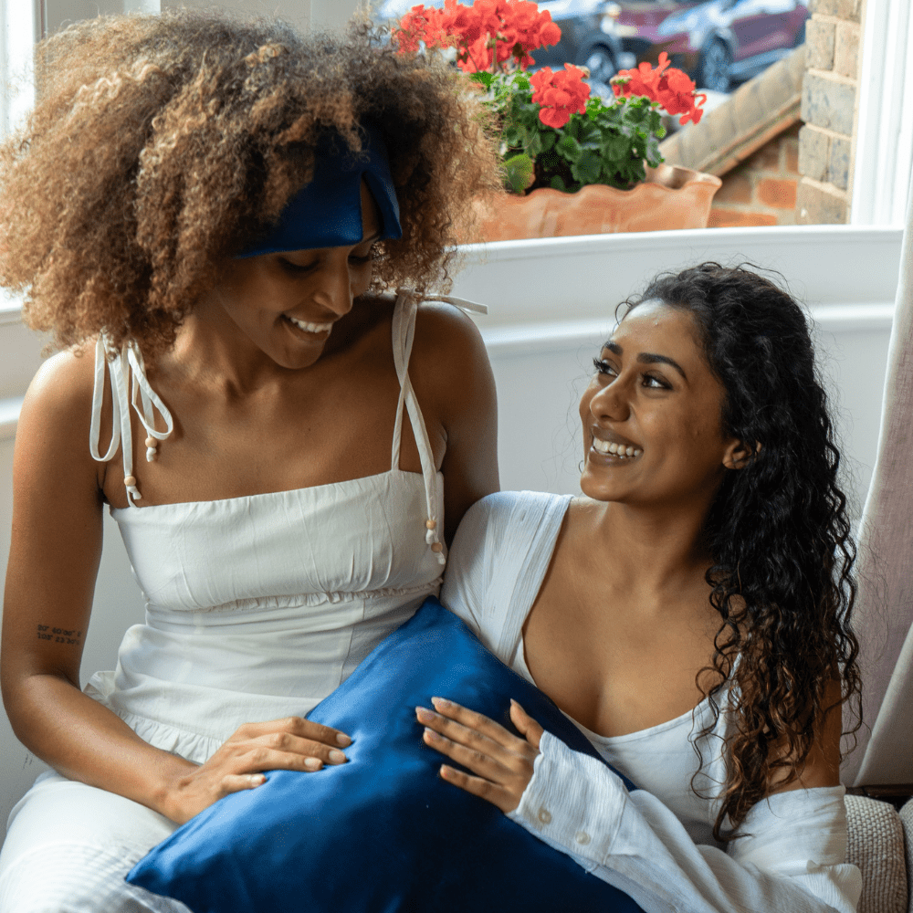 Blue silk pillowcase and silk deep sleep mask with girls laughing 