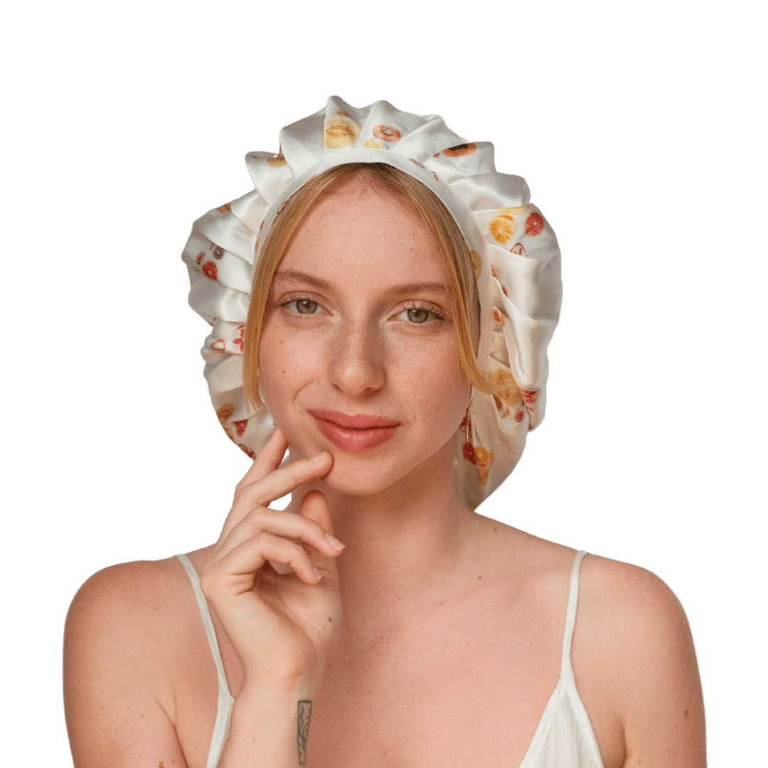 A woman wearing a white silk bonnet with a floral pattern.